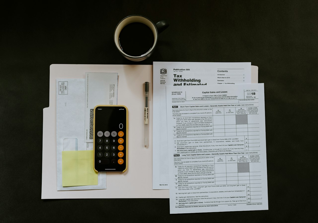 Tax form, pen and phone on a folder