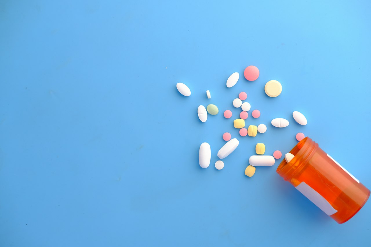 Prescription pills spilling from a pharmacy bottle