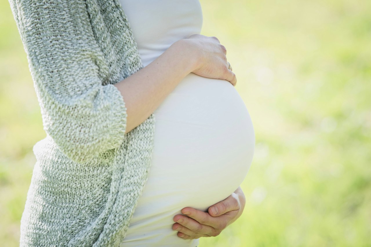 Pregnant woman holding her belly
