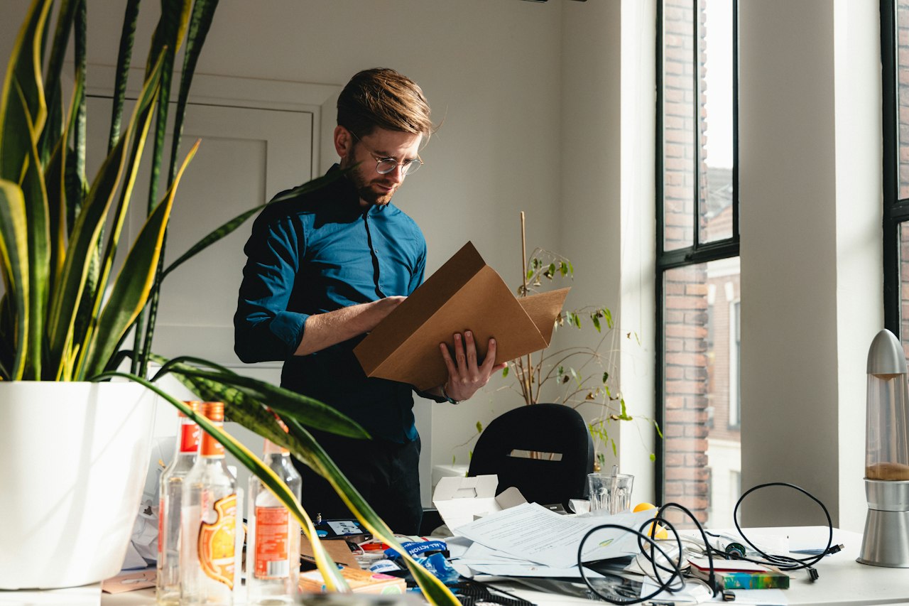 Man clearing out his office desk after leaving a job