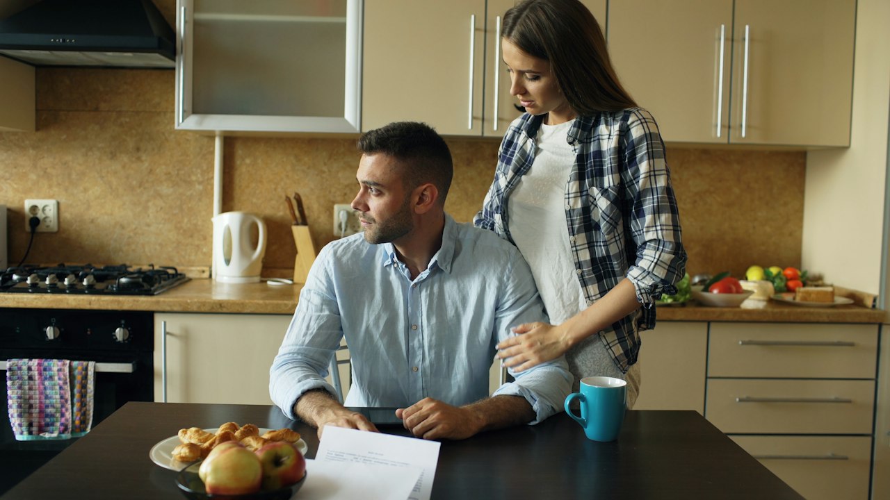 Couple reviewing medical bills at the kitchen table