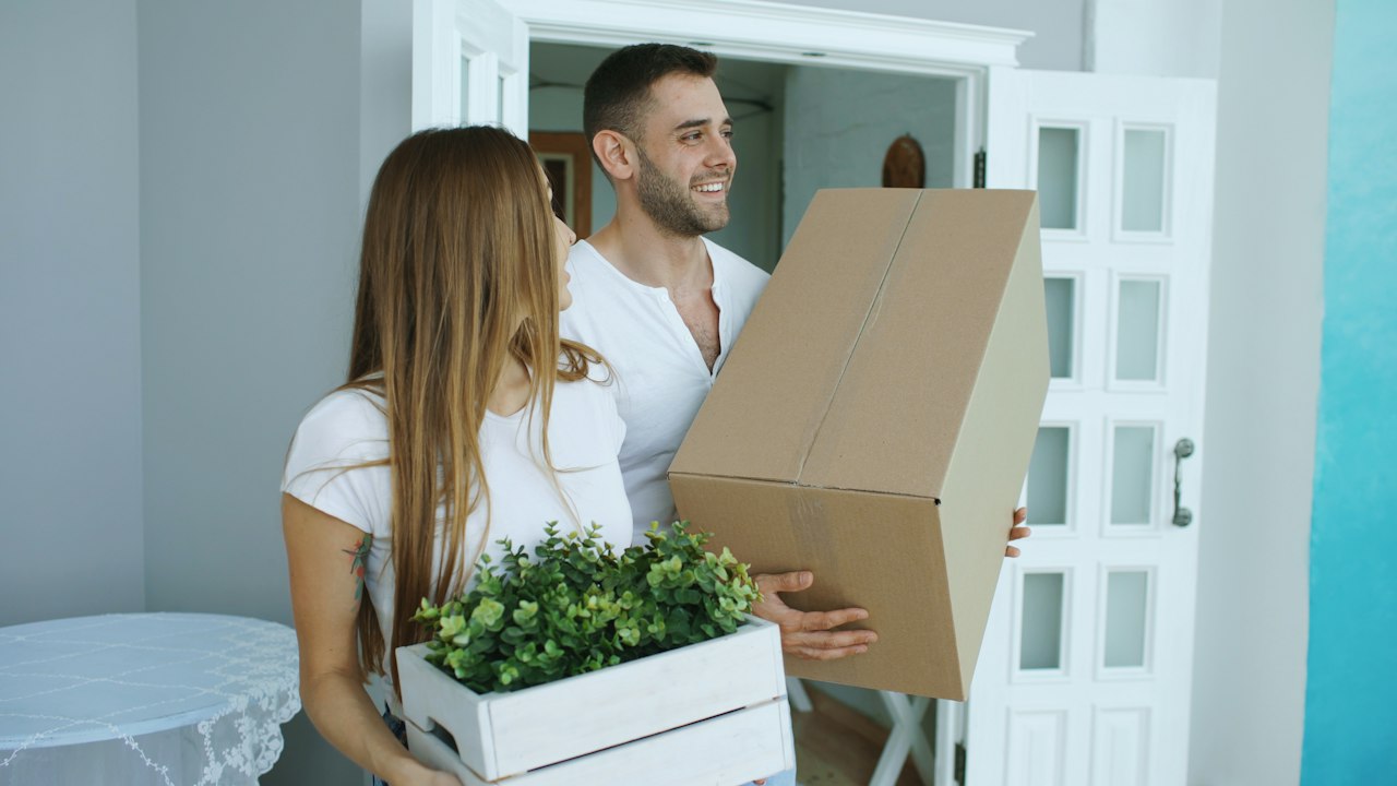 Young couple standing in their new home
