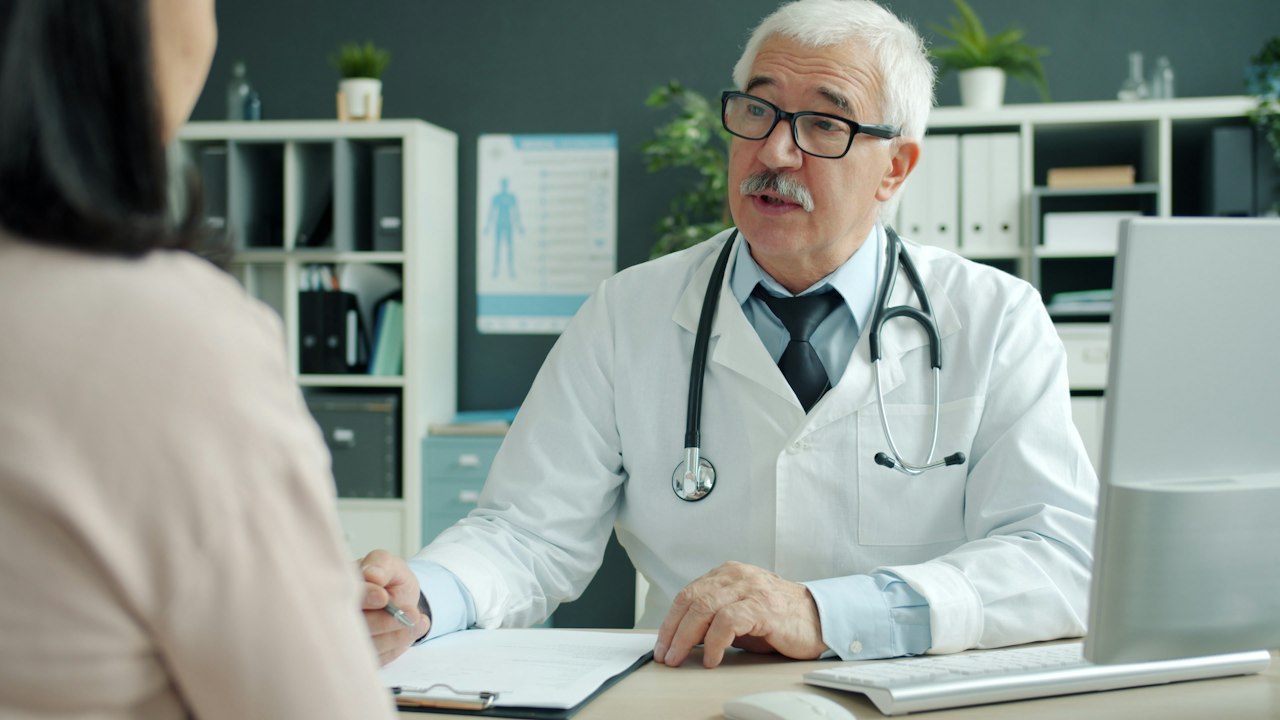 Doctor discussing care options with a patient in a clinic
