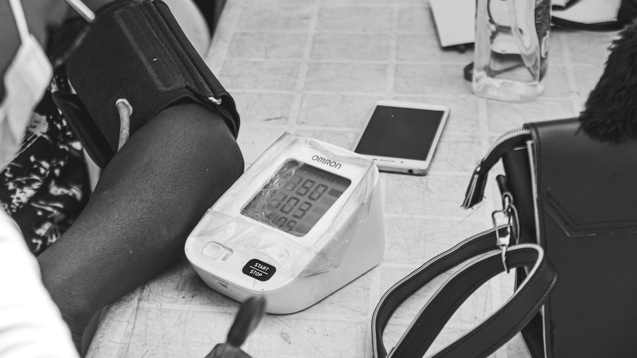 Digital blood pressure monitor on a person's arm
